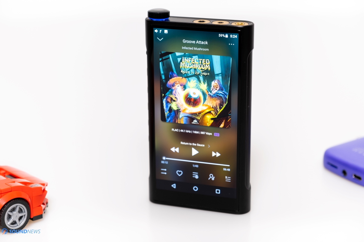 The FiiO M15 screen shows the current track